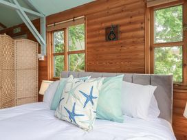 A bedroom with a bed and pillows at The Boat House in Ashprington