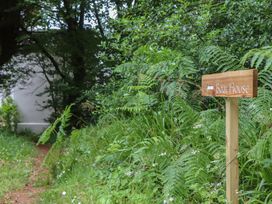 A path leading to a sign for The Boat House in Ashprington