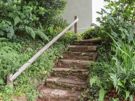 A pathway with stone steps and a handrail at The Boat House in Ashprington