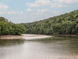 A river surrounded by trees and clouds at The Boat House Ashprington