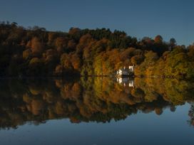 A house near water surrounded by trees at The Boat House Ashprington