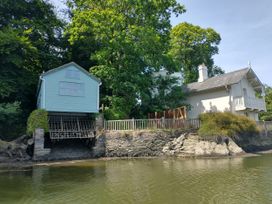 A house and a boat house by the water at The Sharpham Boat House in Ashprington