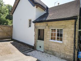 An outdoor area with a door and window at Happiness Cottage in Piddlehinton