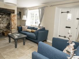 A living room with a sofa and coffee table at Happiness Cottage, Piddlehinton