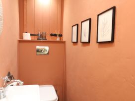 A bathroom with a toilet and sink at Happiness Cottage in Piddlehinton