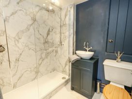 A bathroom with a shower and sink at Happiness Cottage in Piddlehinton