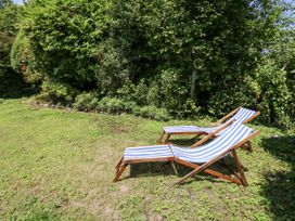 Two deck chairs on grass at Happiness Cottage Piddlehinton