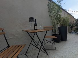 An outdoor area with a table and chairs at Craster House in Seahouses
