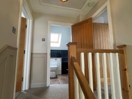 A staircase leading to a bathroom with a toilet and sink at Craster House in Seahouses