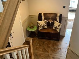 A hallway with a bench and a small table at Craster House in Seahouses