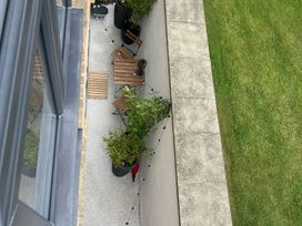 An outdoor seating area with chairs and a table at Craster House in Seahouses