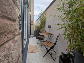 A patio with a table and chairs at Craster House in Seahouses