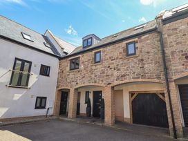 An exterior view of a property with multiple windows and a door at Craster House in Seahouses