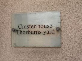 A sign for Craster House at Thorburns Yard in Seahouses