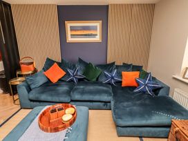 A living room with a sofa and coffee table at Craster House in Seahouses