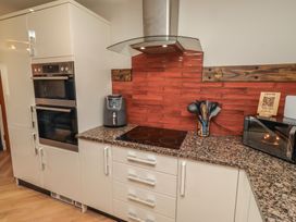 A kitchen with modern appliances and utensils at Craster House in Seahouses