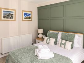 A bedroom with a bed and decorative pillows at Craster House in Seahouses