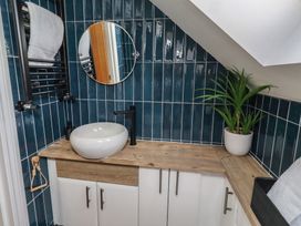 A bathroom with a sink and a mirror at Craster House in Seahouses
