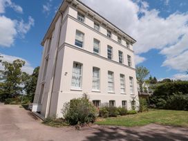 A building with multiple windows and greenery at Flat 2 Battledown Grange in Cheltenham