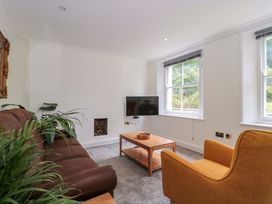 A living room with a sofa and coffee table at Flat 2 Battledown Grange in Cheltenham