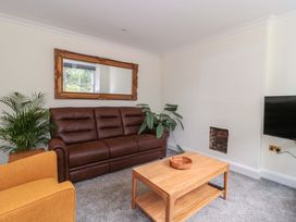 A living room with a sofa and coffee table at Flat 2 Battledown Grange in Cheltenham