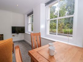 A dining room with a table and chairs at Flat 2 Battledown Grange Cheltenham