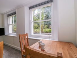 A dining room with a table and chairs at Flat 2 Battledown Grange in Cheltenham