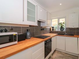 A kitchen with appliances and a sink at Flat 2 Battledown Grange Cheltenham
