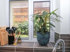 A kitchen with a plant on the window sill at Flat 2 Battledown Grange, Cheltenham