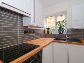 A kitchen with a sink and cabinets at Flat 2 Battledown Grange Cheltenham