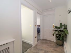A hallway with a plant and doors at Flat 2 Battledown Grange, Cheltenham