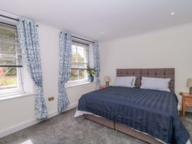 A bedroom with a bed and curtains at Flat 2 Battledown Grange, Cheltenham