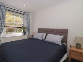 A bedroom with a bed and window at Flat 2 Battledown Grange Cheltenham