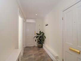 A hallway with a door and a plant at Flat 2 Battledown Grange Cheltenham