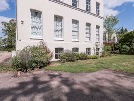 An outdoor area with plants and windows at Flat 2 Battledown Grange in Cheltenham