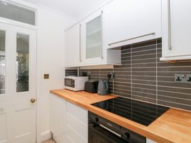 A kitchen with a microwave and kettle at Flat 2 Battledown Grange in Cheltenham