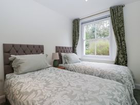 A bedroom with two single beds and a window at Flat 2 Battledown Grange in Cheltenham