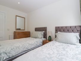 A bedroom with two single beds and a mirror at Flat 2 Battledown Grange Cheltenham