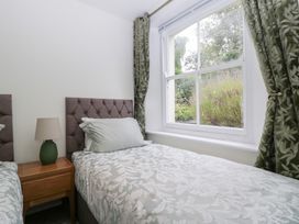 A bedroom with two beds and a window at Flat 2 Battledown Grange in Cheltenham