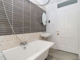 A bathroom with a bathtub and sink at Flat 2 Battledown Grange in Cheltenham