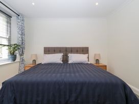 A bedroom with a bed and lamps at Flat 2 Battledown Grange, Cheltenham