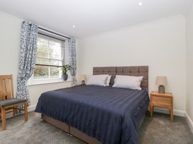A bedroom with a bed and a bedside table at Flat 2 Battledown Grange in Cheltenham