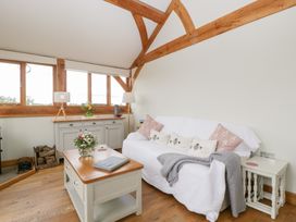 A living room with a sofa and coffee table at Little Acorn Cottage in Munsley near Ledbury