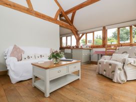 A living room with sofa and coffee table at Little Acorn Cottage Munsley near Ledbury