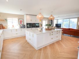 A kitchen with an island and modern appliances at Ardwyn Rhosneigr