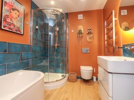 A bathroom with a shower and bathtub at Ardwyn Rhosneigr