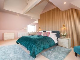 A bedroom with a bed and bedside tables at Ardwyn in Rhosneigr