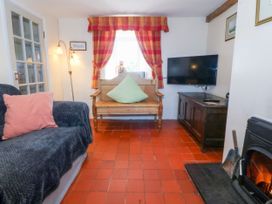 A living room with a sofa and a television at Brynffynon in Pwllheli
