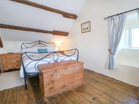 A bedroom with a bed and chest at Brynffynon in Pwllheli