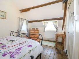 A bedroom with a bed and a chest of drawers at Brynffynon in Pwllheli